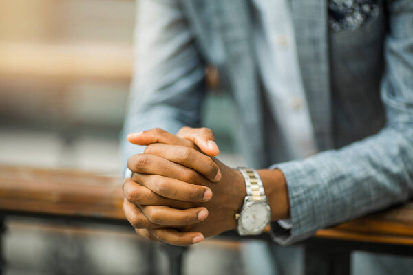 hands of a man in a suit with a watch