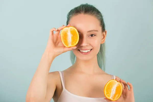 stock image beautiful slender young woman in sportswear with oranges in her hands