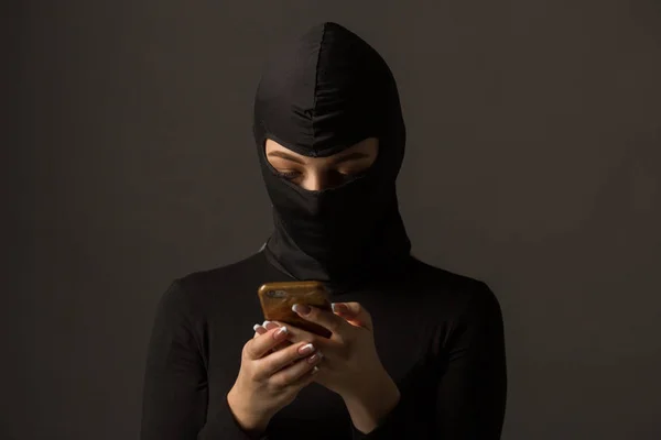 Okänd Kvinna Svart Mask Med Telefon Händerna Grå Bakgrund — Stockfoto