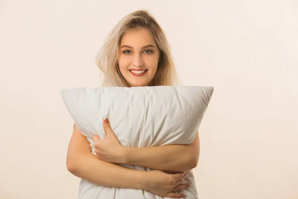Beautiful Young Woman Beige Background Pillow Her Hands — Stock Photo, Image