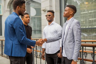 Yazın binanın yanında dört Afrikalı genç adam.