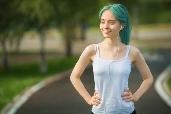 痩せた姿の美しい若い女性が公園で夏にジョギングしています — ストック写真