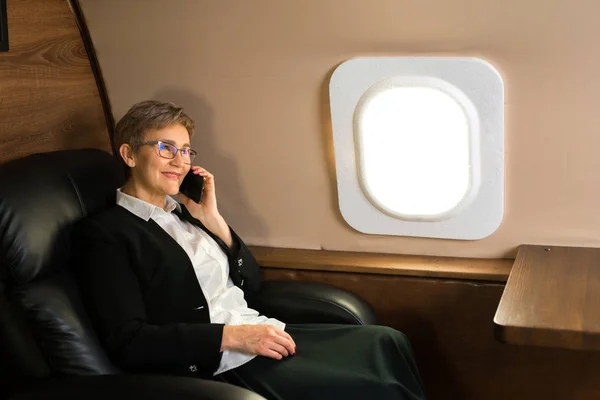 Hermosa Anciana Cabina Avión Privado Sillón Con Teléfono Sus Manos — Foto de Stock