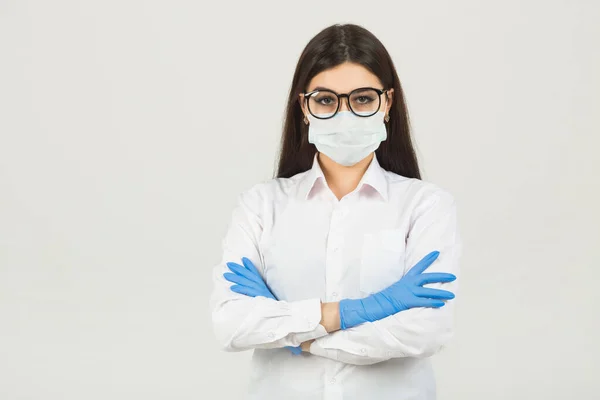young woman in medical face mask on a white background