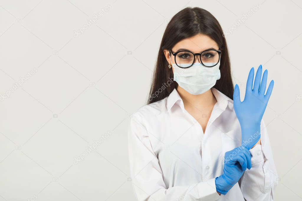 young woman in medical face mask on a white background