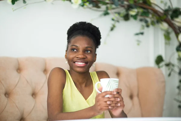 beautiful young african woman in yellow t-shirt