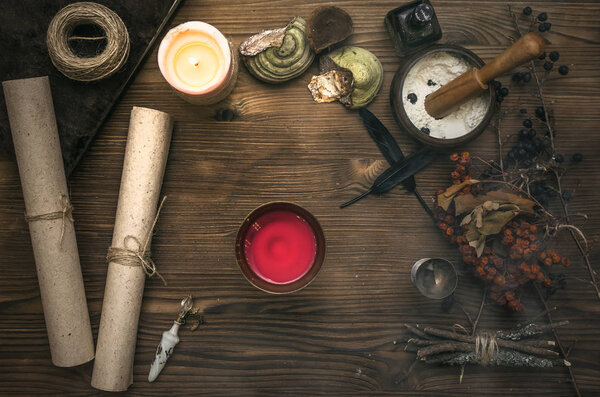 Ancient magic scroll on wooden desk table. Witchcraft. Witch doctor desk table. Magic potion. Alternative medicine concept.
