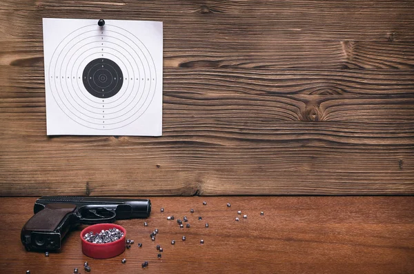 Gun pistol and paper target. Shooting practice. Shooting range background with copy space.