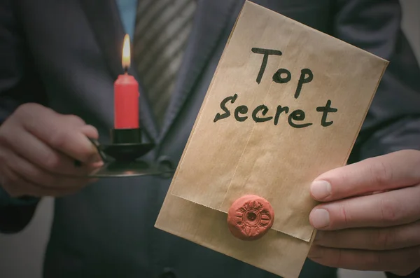 Top secret concept. Top secret documents or message in businessman hands. Confidential dossier information. Super important information.