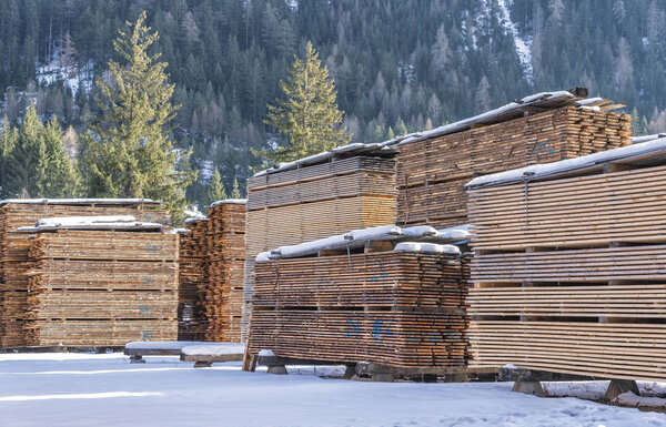 Drying timber boards at the sawmill in winter Alp Mountains