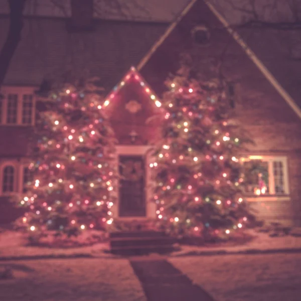 Seasonal Christmas House Lights Decoration, outdoor blurred defocused view. Xmas showcase