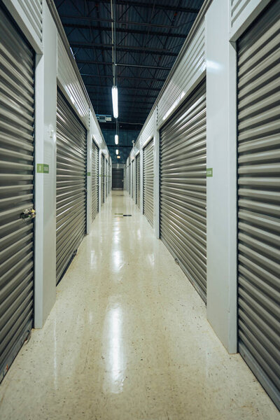 Long storage facility corridor. Garage doors with light