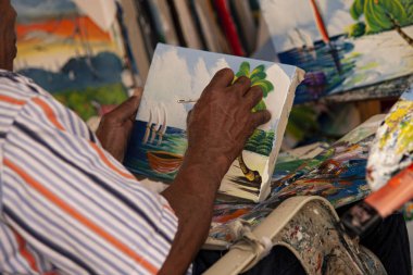 Dominican painter paints 2 clipart