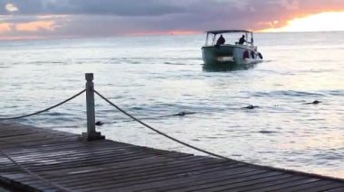 BAYAHIBE, DOMINICAN REPUBLIC 8 JANUARY 2020: Sailboat at horizon in caribbean sea at sunset
