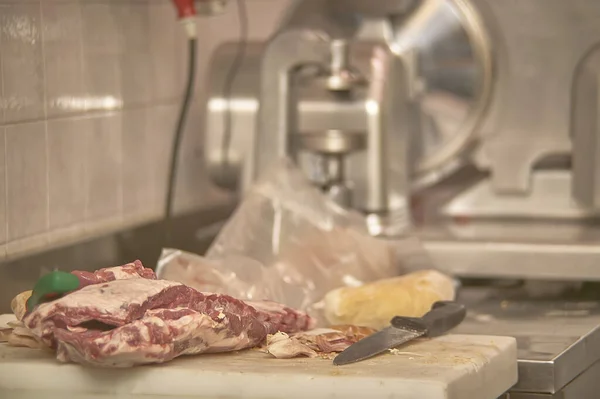 Butcher prepares the cuts of meat for sale