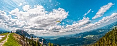 Alp mountain landscape with parachute clipart