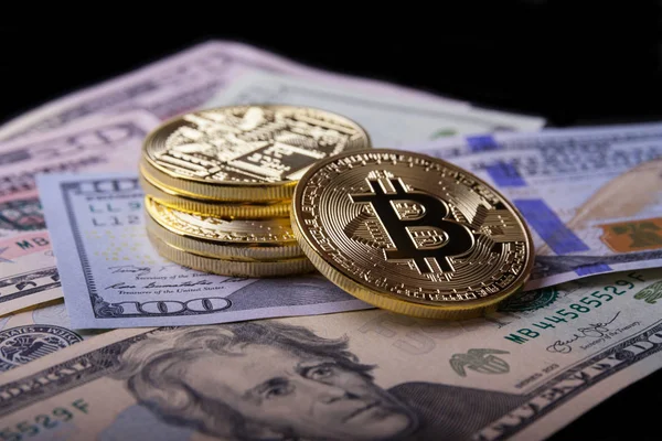 Golden bitcoin on dollar bills. Royalty Free Stock Photos