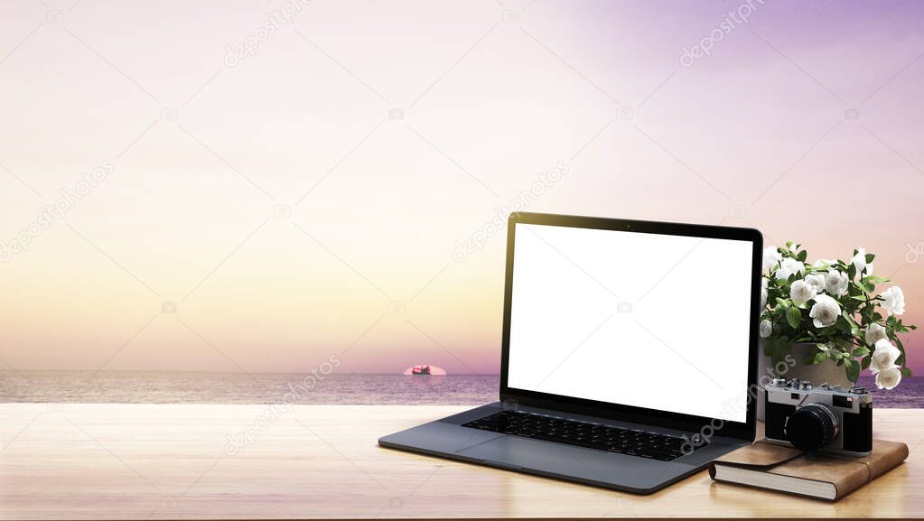 Work from home space and workplace for bussiness and notebook computer and mobile phone and sea vew and sunset background