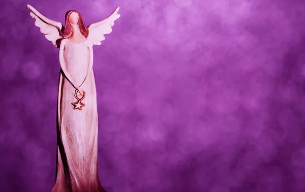 クリスマスの天使は紫のボケ味の背景に — ストック写真