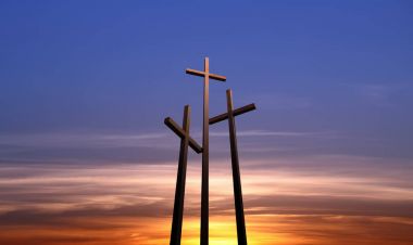 Three crosses over bright sunset background clipart