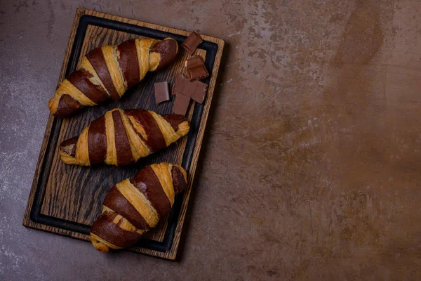 Čokoládový croissant a čokolády na stole — Stock fotografie