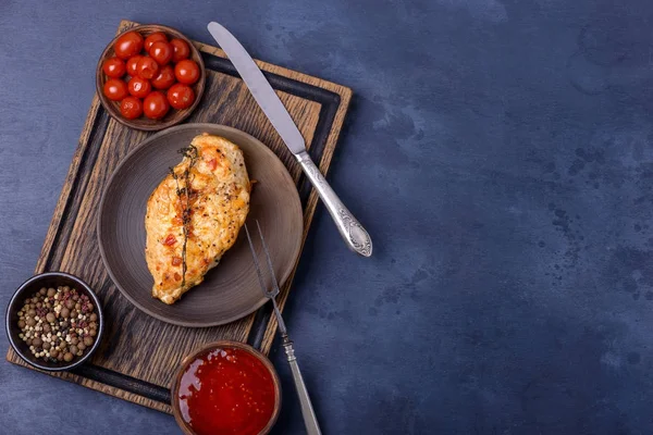 Breast chicken and ketchup on cutting board — Stock Photo, Image