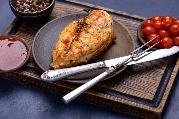 Grilled breas chicken on plate with cutlery — Stock Photo, Image