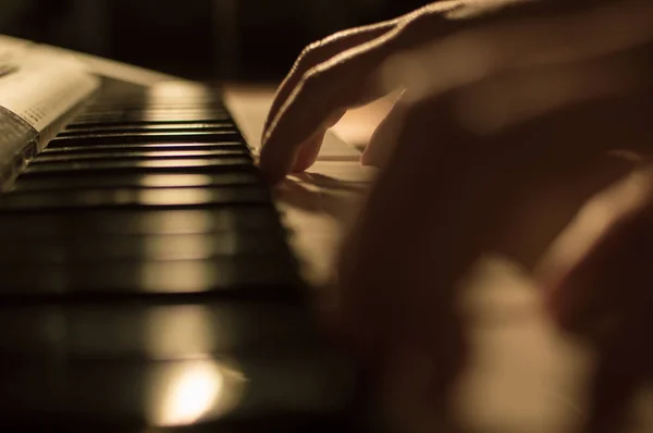 Close-up soft focused atmospheric photo of a hand playing the piano keys. Concept: Music creating, composing, lyrics, performance — Stock Photo, Image