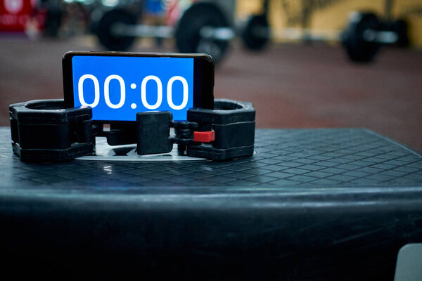 Timer on the stepper platform in the gym before the athlete starts to record video for online qualifier for international crossfit competition