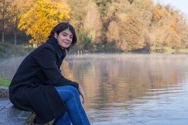 Nehir kıyısında saçları olan kız.