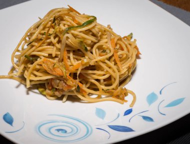 Saut��ed spaghetti with vegetables