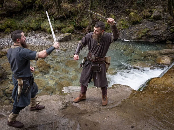 Two viking warriors duel with the sword