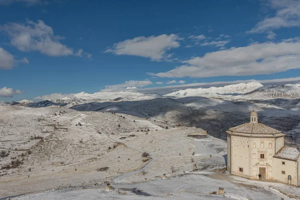Top view of the snowy mountains of Abruzzo and the church of San — Stock Photo, Image