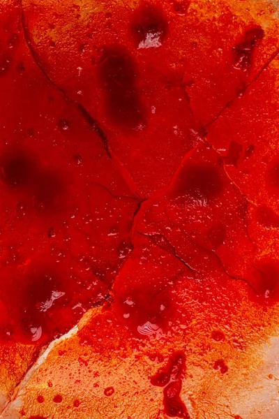 Image of blood-colored liquids mixed with other organic fluids, abstract chemical detail