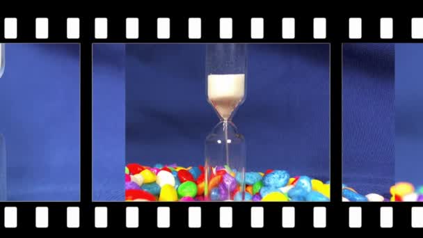 Hourglass on a Blue background, the sand falls inside. — Stock Video