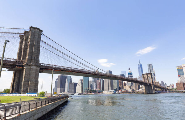 BROOKLYN, NYC - Jily 20: Brooklyn Bridge from Brooklyn Bridge Park, DUMBO, NYC seen on July 20, 2016. The park on the East River offers magnificent view of historic, landmark Brooklyn Bridge.
