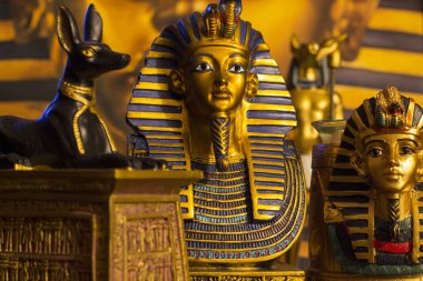 Still life of statues of king pharaoh tutankhamun tutankhamen and mythology jackal anubis inpu anup clipart