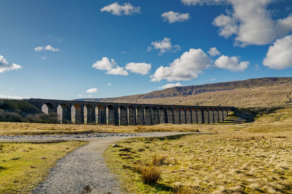 A distant view of the Ribblehead viaduct, on a sunny day