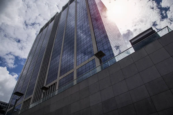 Hög business byggnad i centrum av bakgrunden av dramatiska blå himmel — Stockfoto