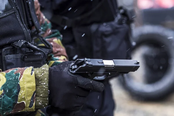 soldiers train shooting with a gun. a group of soldiers are practicing in cold snowy weather. perfectly equipped with equipment and camouflage clothing in muddy and dirty weather.