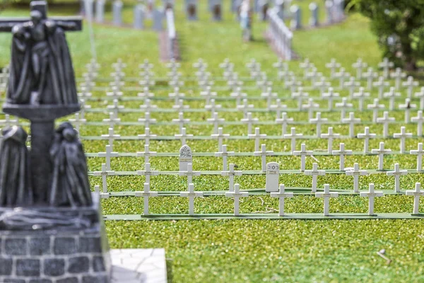 Miniature cemetery park with many white crosses of green grass.buried soldiers of the war. heroes in our time.