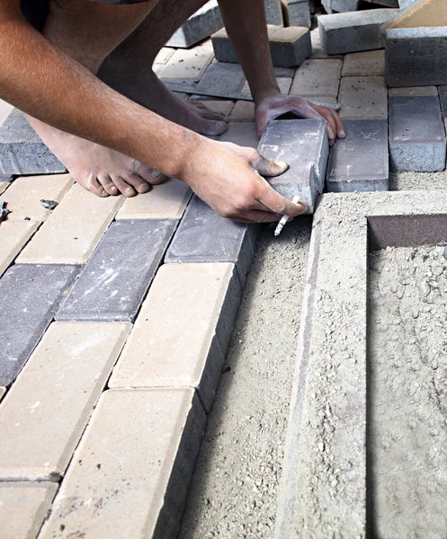 The employee puts the paving slab on the sidewalk Royalty Free Stock Photos