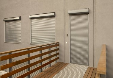 Metal blinds on the doors and windows of the facade of the house clipart