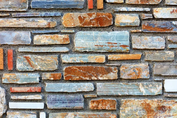 Multicolored stone multifaceted mosaic sandstone texture closeup