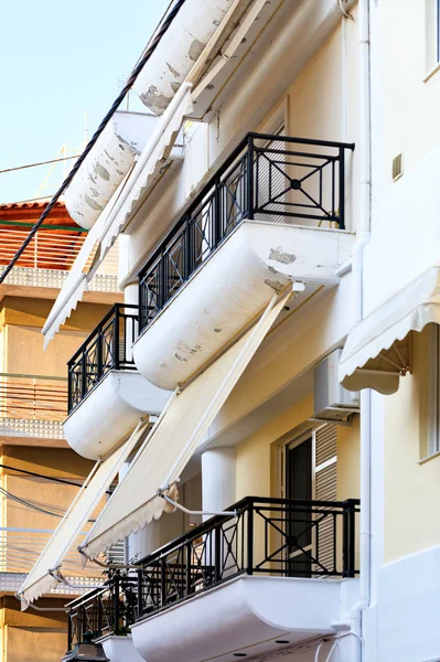 Balcony fabric awnings protect windows from sunlight.