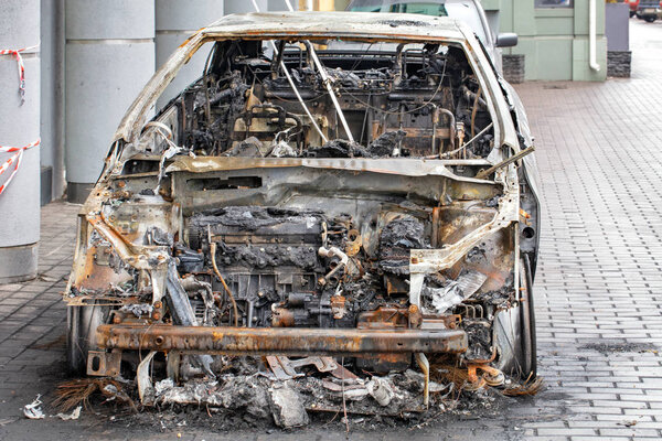 The interior of a burned-out car interior, front view.