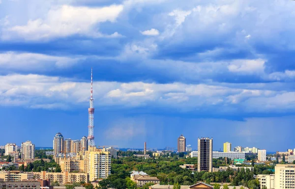 TV tower and residential areas of Kyiv at noon against the backdrop of a stormy blue summer sky. — Stock Photo, Image