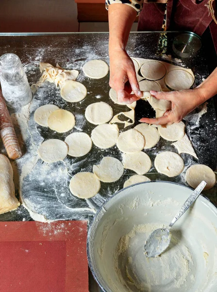 Женщина, использующая скалку и стекло, готовит тесто для пельменей. . — стоковое фото
