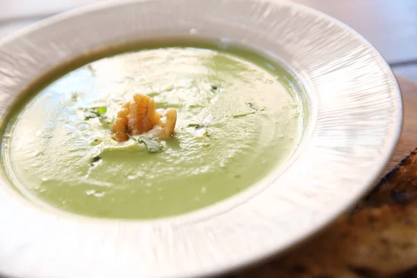 Broccoli cream soup on wooden table — Stock Photo, Image