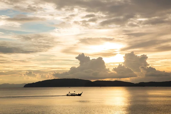 Blue golden sky in sunset with sea and boat